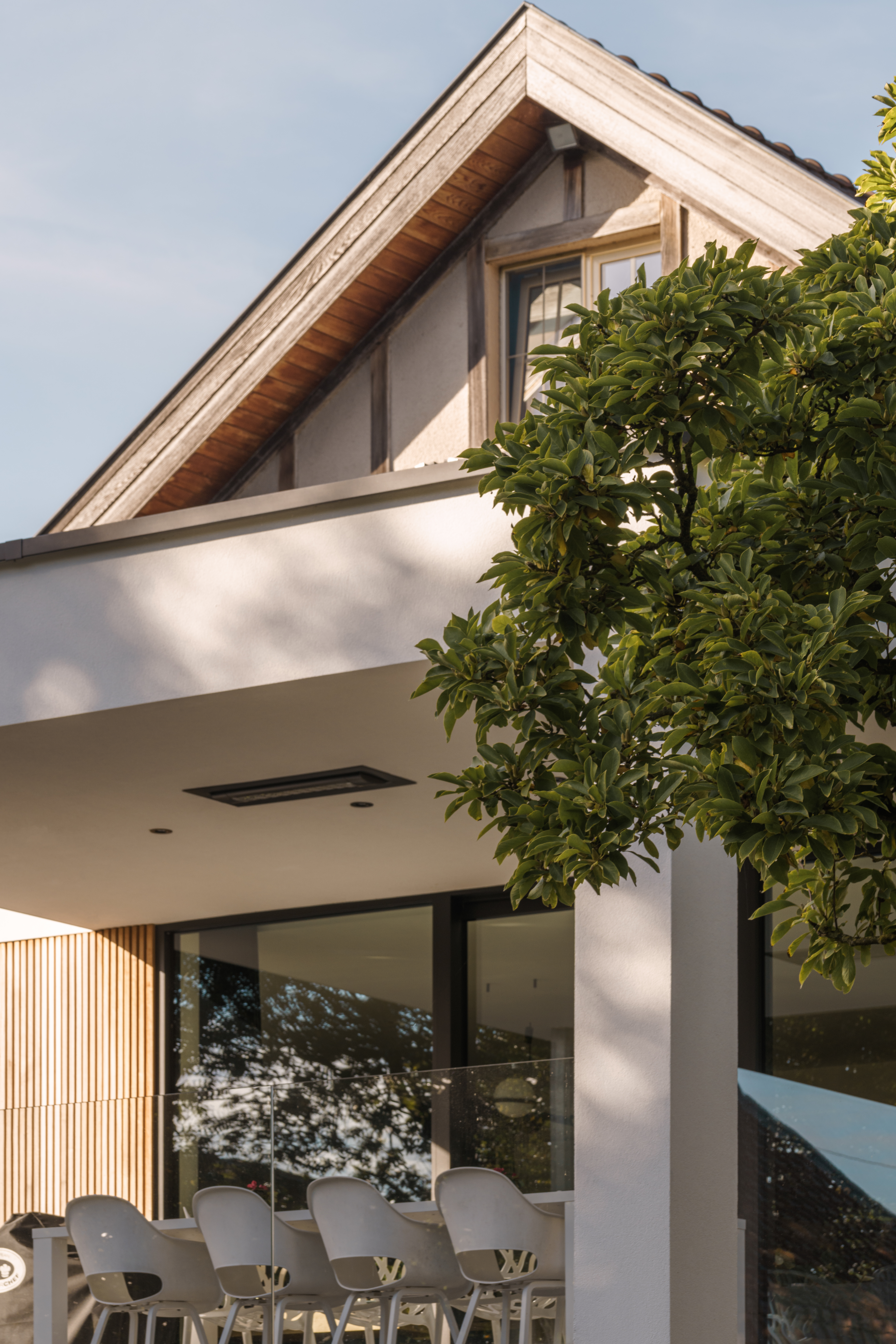 Moderne nieuwbouwwoning in open bebouwing met zwart aluminium ALU Visoglide Monorail-schuifraam, grote glaspartijen en overdekt terras.